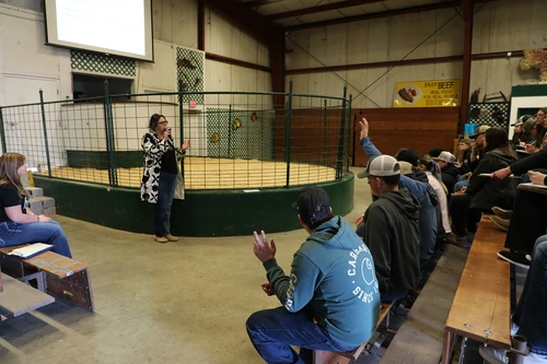Woman talking to students.